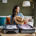 Woman packing clothes for travel